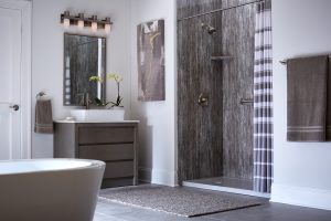 A sleek walk-in shower with dark a grey wall surround in a Bel Aire, KS, bathroom
